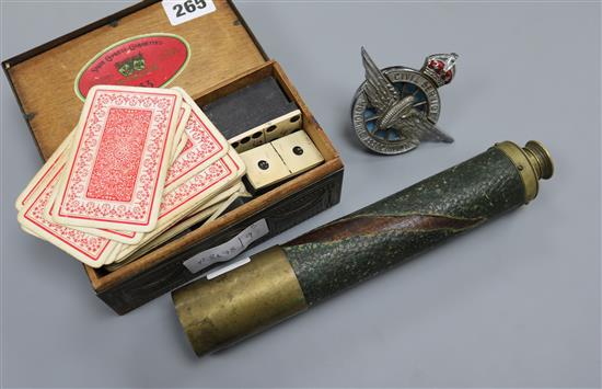 A brass telescope, cigarette box and car mascot